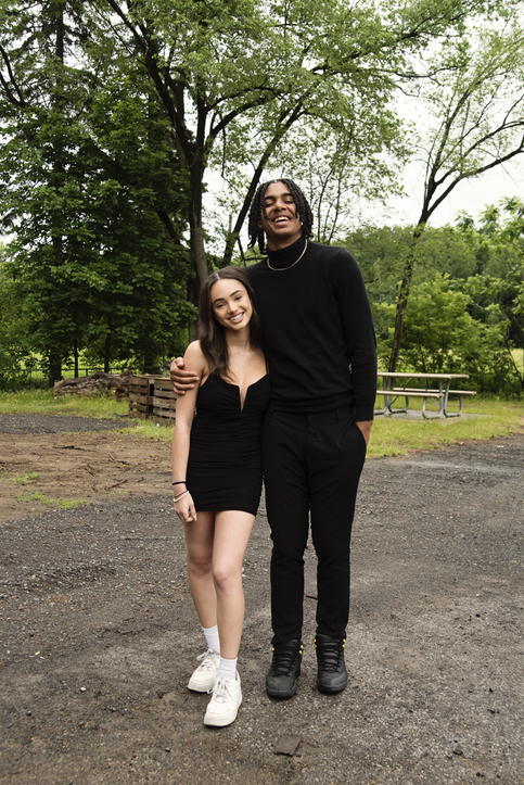 Ein glückliches Paar mit sichtbarem Größenunterschied steht in einem Park. Das Bild symbolisiert, wie ein Größenfilter beim Online-Dating die Partnerwahl anhand von persönlichen Suchmustern beeinflusst.
